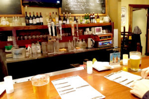 View of Japanese karaoke bar, someone drink beer on the counter in the US