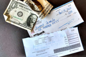 US dollar note and US bank check for paying rent cost