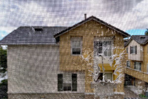 The view of homes from the screen door window.