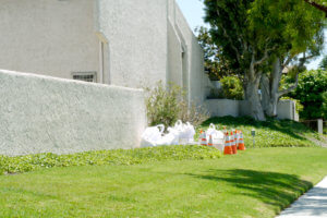 Traffic cones on lawn front of the white wall house