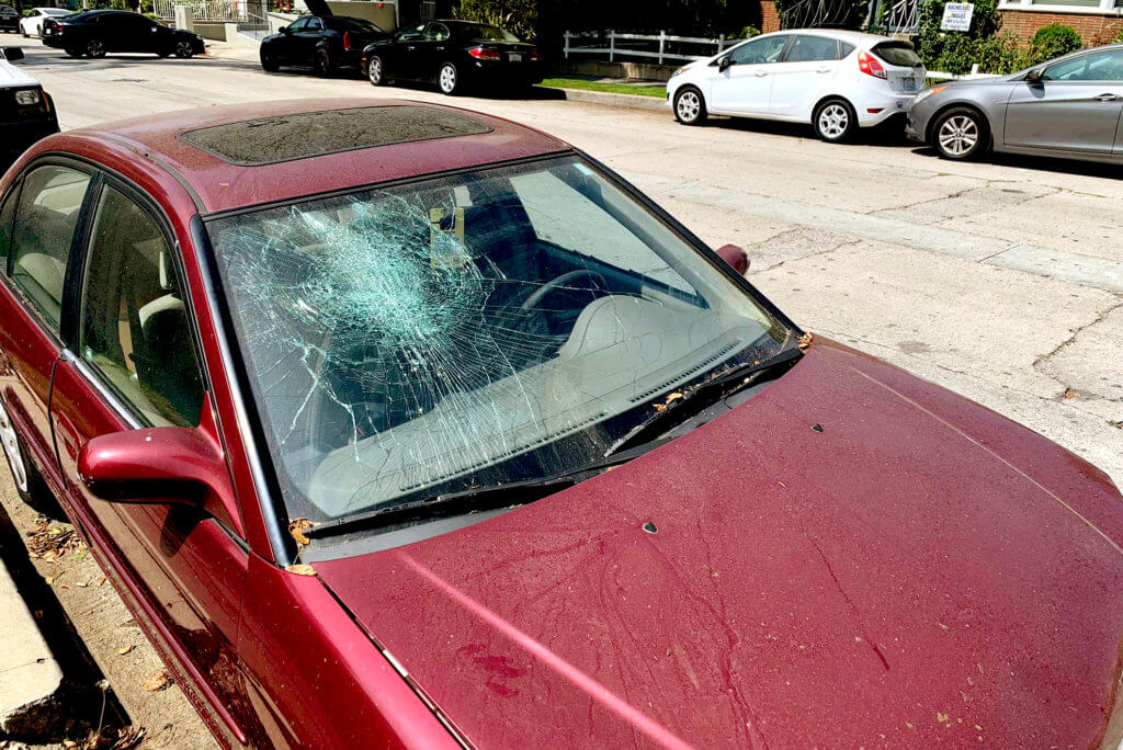This is vandalism, broken the car's front window