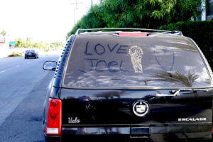 Finger drawing that love joel on the car windows