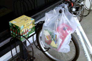 A bicycle and beer plastic bag