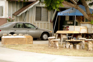 A Coffin and a car at the yard in the California