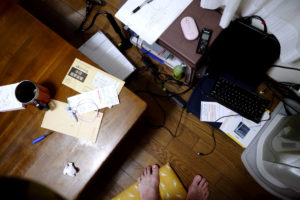 Messy table, computer and foot