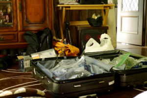 Unpacked Suit case on the floor in living room