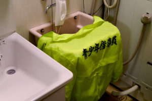 Youth instructor jacket hang on wash basin