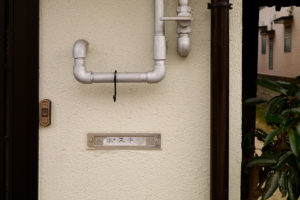 Post on the house wall and pipes