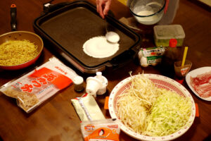 Cooking okonomiyaki in Japan Hiroshima