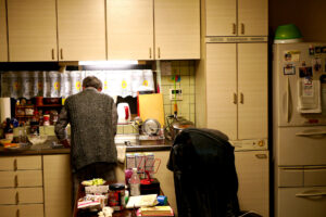 My father wash dishes on the kitchen