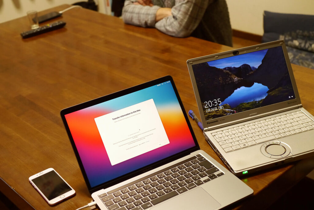 macbook and windows laptop on the table