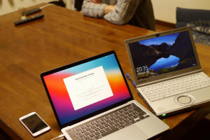 macbook and windows laptop on the table