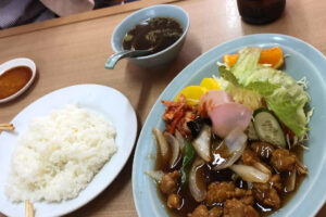 Chinese dishes sour pork and rice on the table