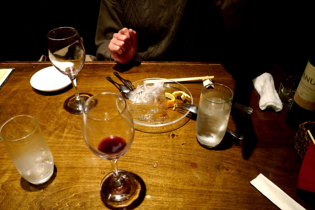 Wine glasses and dishes on the table at restaurant Hiroshima Japan