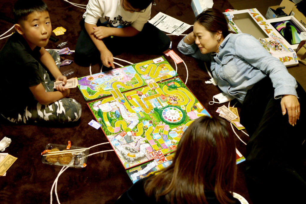 Japanese family playing life games at living room