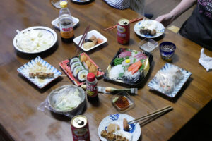 Packed meals like roll sushi, sashimi, yakitori and just cutting cabbage on the table in Hiroshima Japan