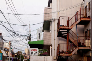 Electrical wire and an old iron stairs in a small town in Hiroshima Japan