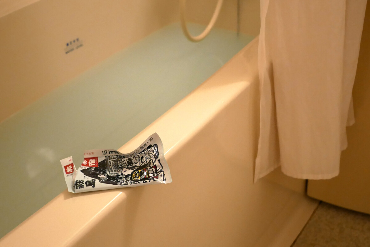 Bath room A bathtub with white hot water containing bath salts at Sotetsu grand fressa in Hiroshima Japan