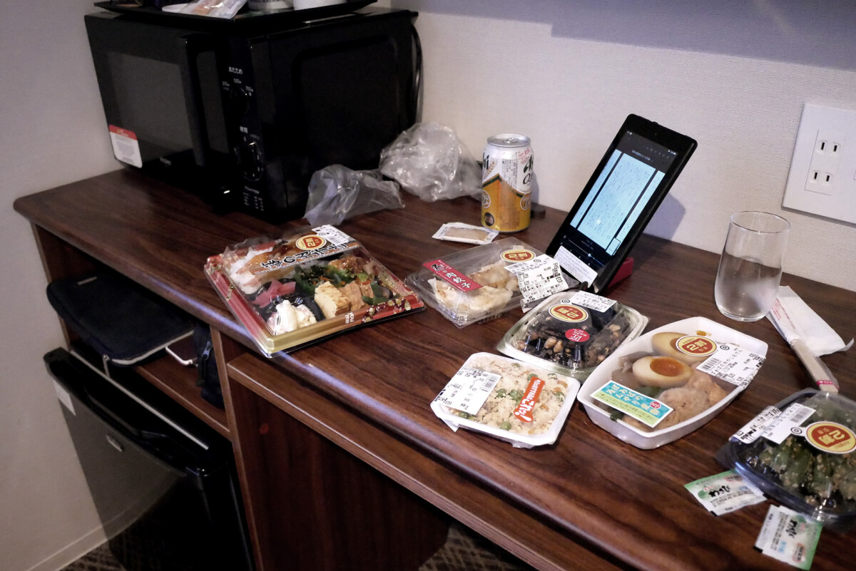 bento and canned beer bento and pre cooked meal on the table at Livemax hotel room in Hiroshima Japan