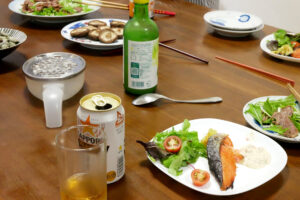 Canned Beer, salmon fillet and grilled mushrooms at Japanese family on the table in Hiroshima Japan