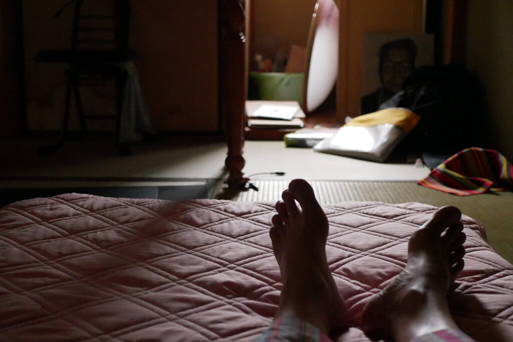 Man's Feet on the futon bed in the early morning lights in Hiroshima Japan