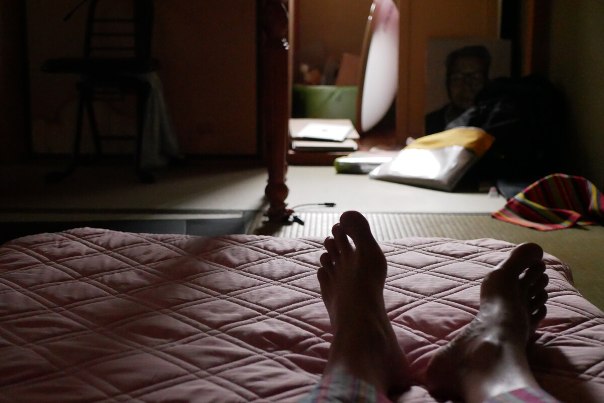 futon mat Man's Feet on the futon bed in the early morning lights in Hiroshima Japan