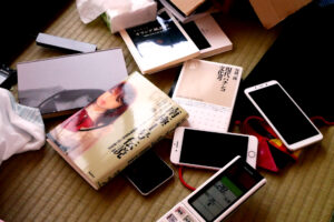 Sex Dolls book and normal books and mobile phones on the tatami mat floor in Hiroshima Japan