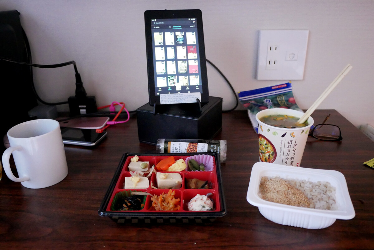 Japanese Breakfast Japanese bento dishes, instant rice, miso soup, tablet kindle fire on the desk at at hotel room in Hiroshima Japan