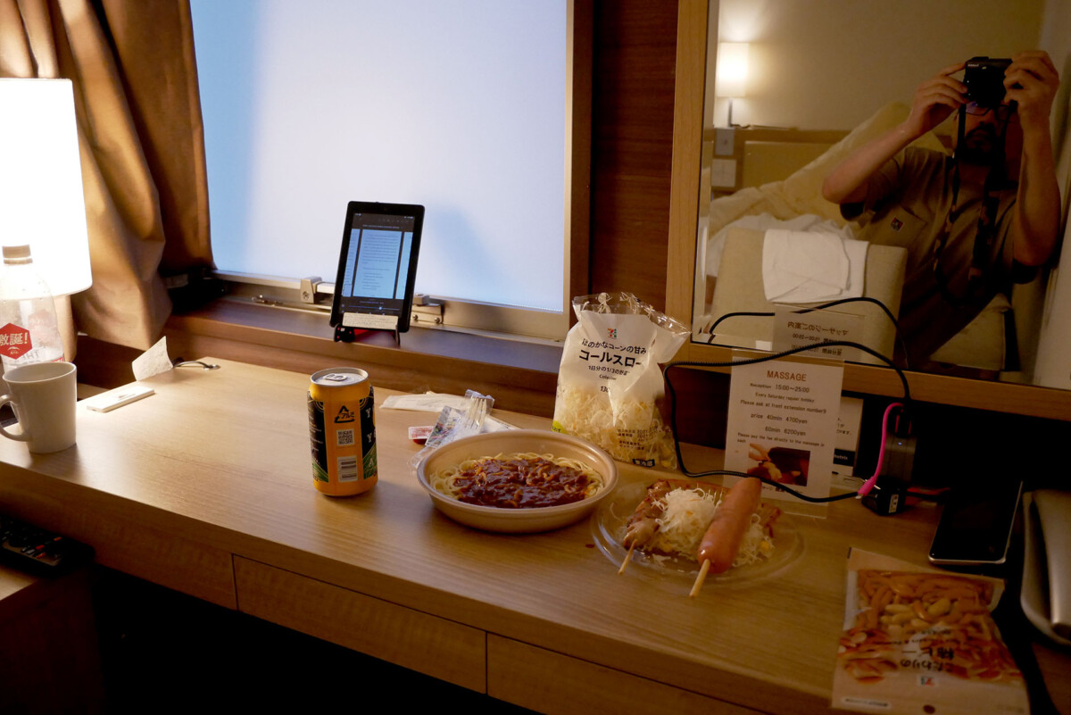 Junk food dinner Pre cooked meal and canned beer on the table at KOKO hotel's room in Hiroshima Japan