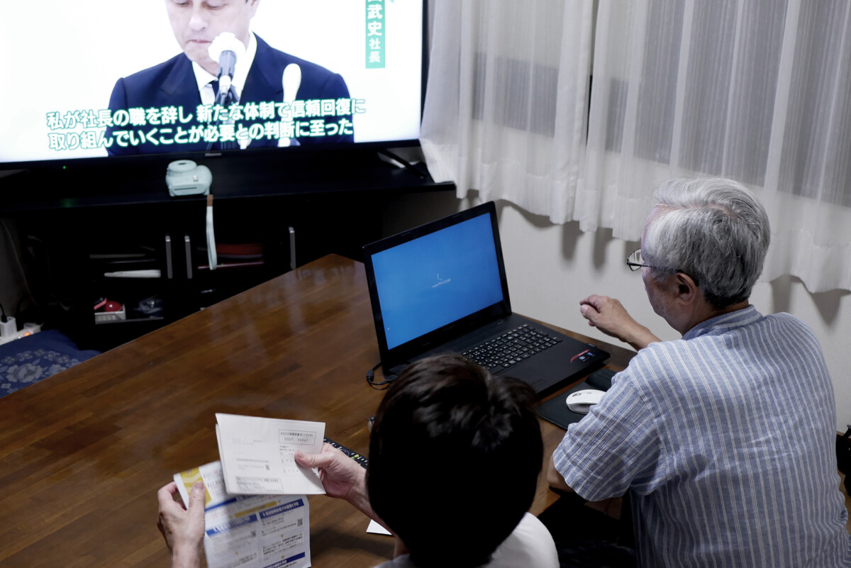 Old parents Old parents at the Japanese dining room. A dad is handling laptop to reserve for Covid-19 vaccination.