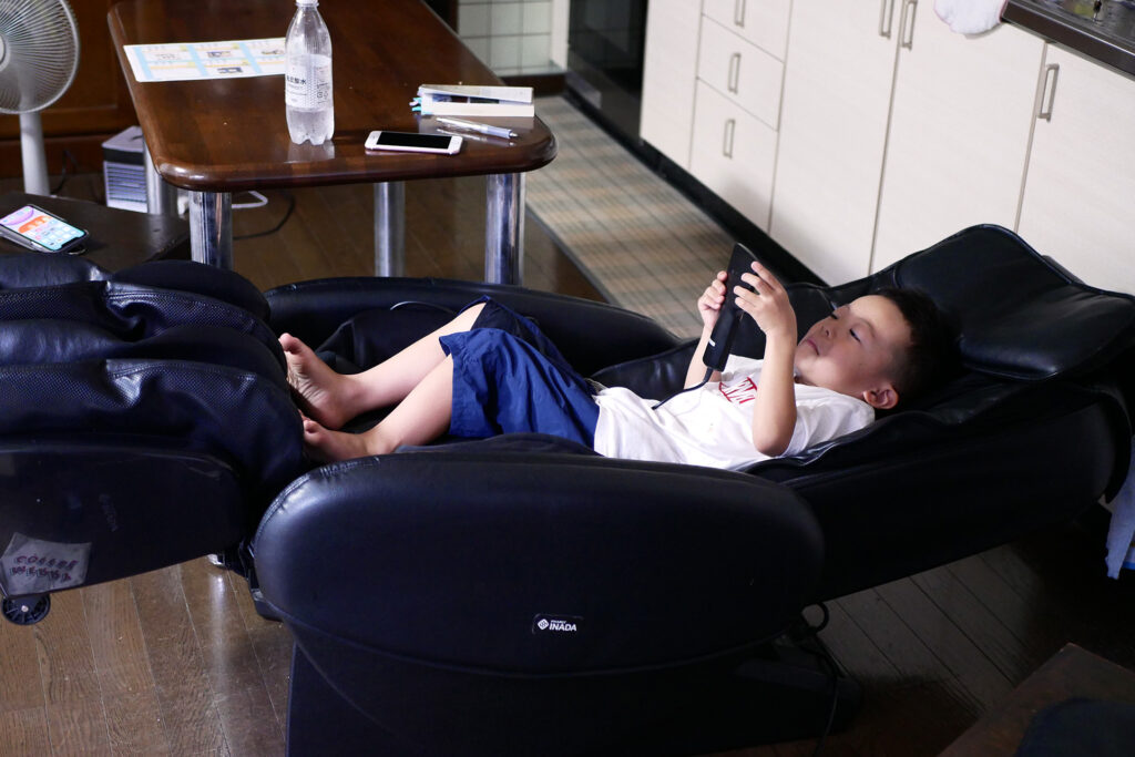 A boy lay on the massage chair in Hiroshima Japan