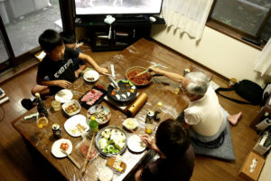 Boys and elder people eating BBQ at Japanese house in Hiroshima Japan