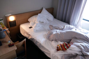 The view of Hiroshima Sotetsu Hotel room's bed which is after sleeping a man