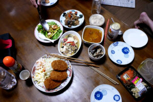 Japanese meals like crockets, salad, curry, fried shrimp on the table