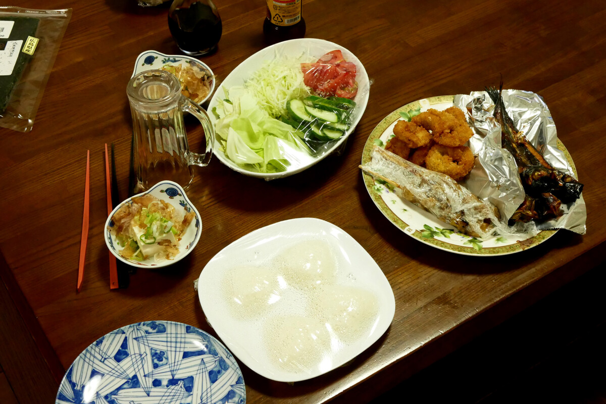 Japanese daily dishes Salad, grilled fish, rice ball such Japanese daily dishes on the wooden table