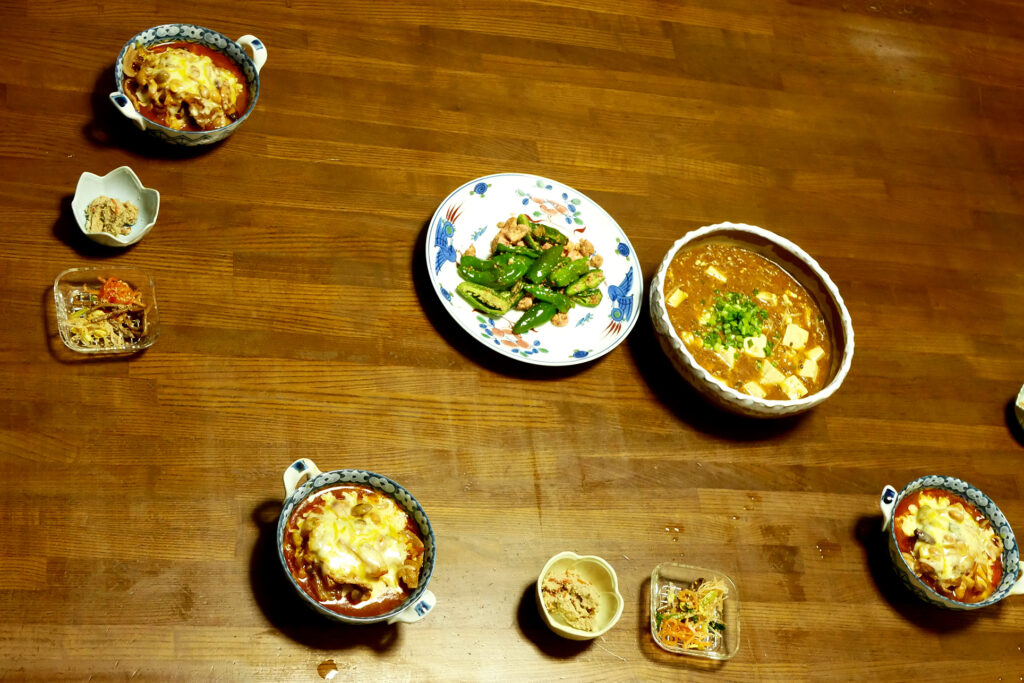 Japanese daily dishes like mapo-tofu kobachi and tomato soup on the table
