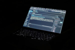 A laptop Macbook Pro in the dark that displayed WordPress admin page