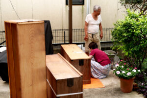 Elder parents are dismantling an old harmonica drawers at yard