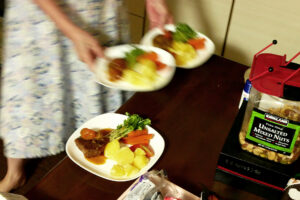 Serving dishes of hamburg Steak, nuts box on the wooden table