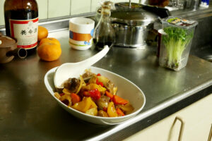 Homemade sweet and sour pork dish and Yomeishu on the kitchen