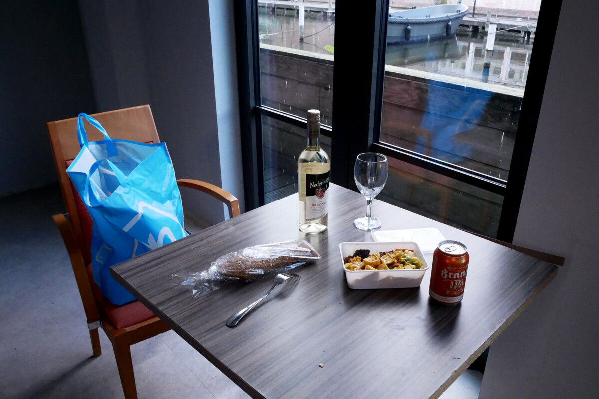 My dinner Bread, packed Indonesian food, a bottle of white wine on the table in the Netherlands