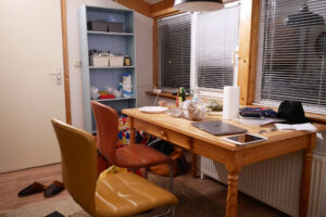 There are two chair, a wooden desk at an Europe room in the Netherlands