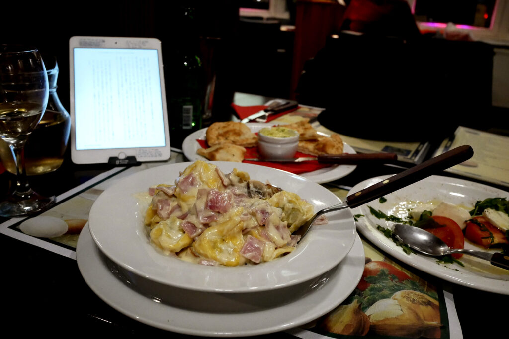 Pasta, iPad, bread on the table at Italian restaurant in the Netherlands