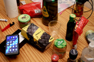 New mobile phone, and bottle of seasonings on the wooden table