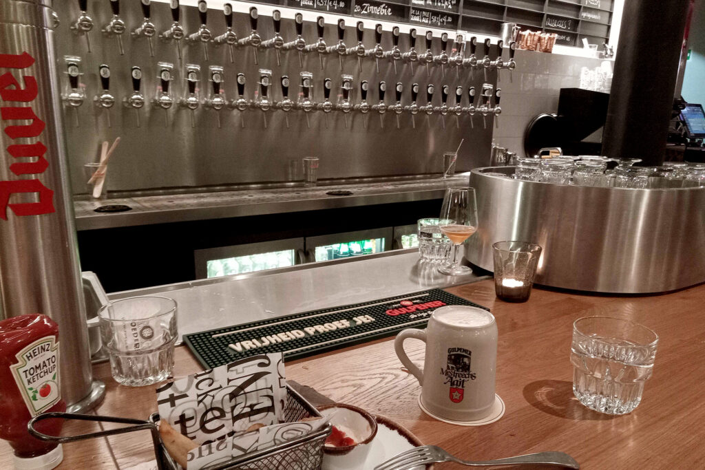 beer server, snacks and cup of beer on the bar counter