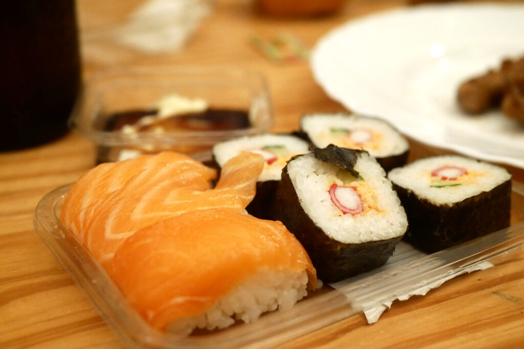 Packed sushi made in Netherlands on the wooden table