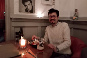 An Asian man be seated in the restaurant in the Netherlands