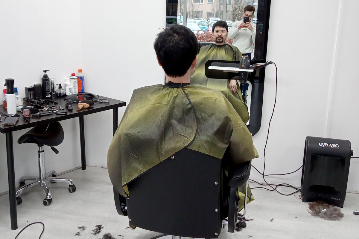 An Asian man was cut his hair at the barber in the Netherlands