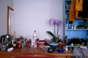 Flower, water bottle, seasonings on the wooden desk