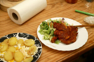 Pork steak and sliced potato on the wooden table